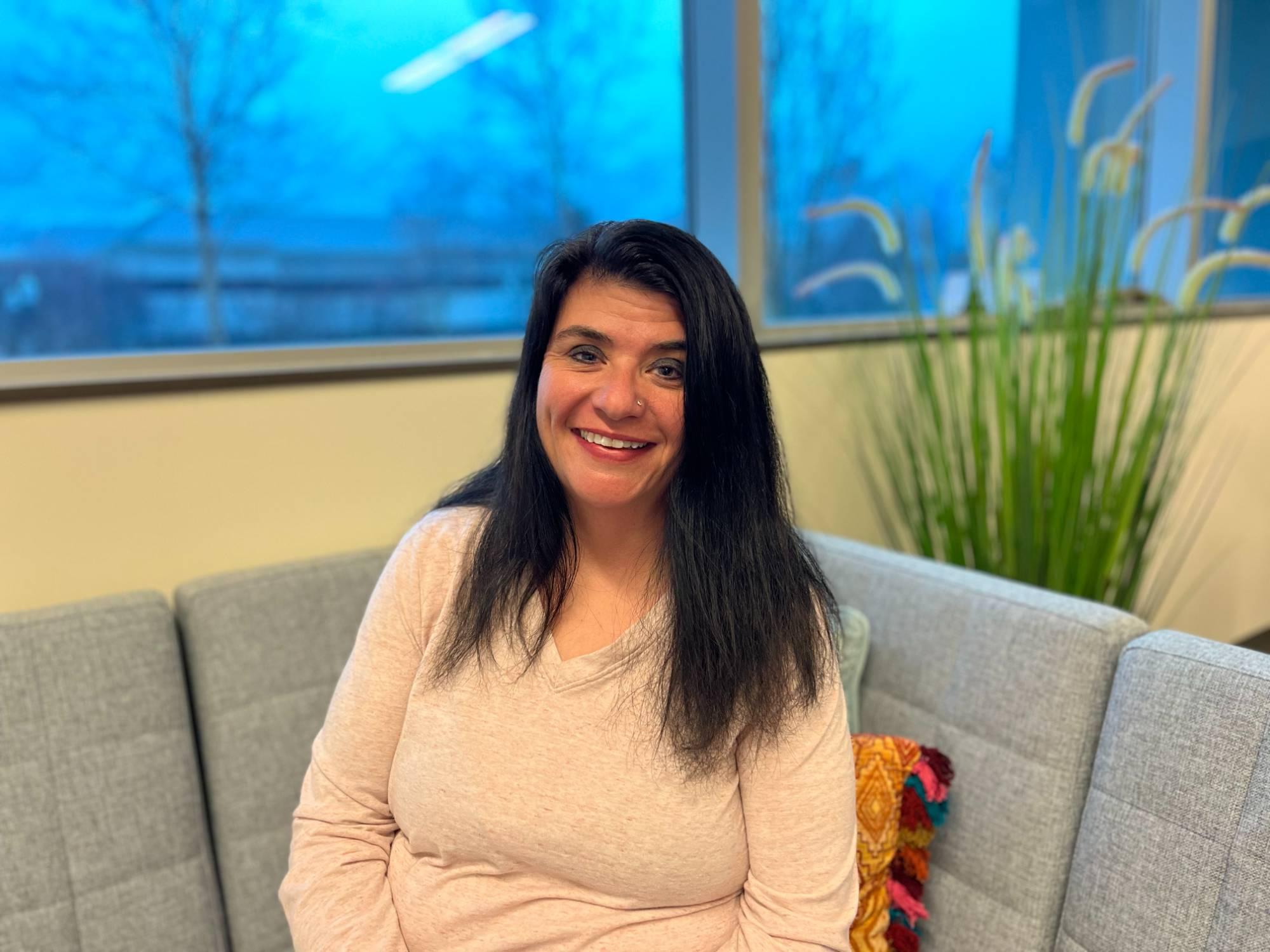 Charity Anderson smiling for a photo in the Talent Management office at GVSU